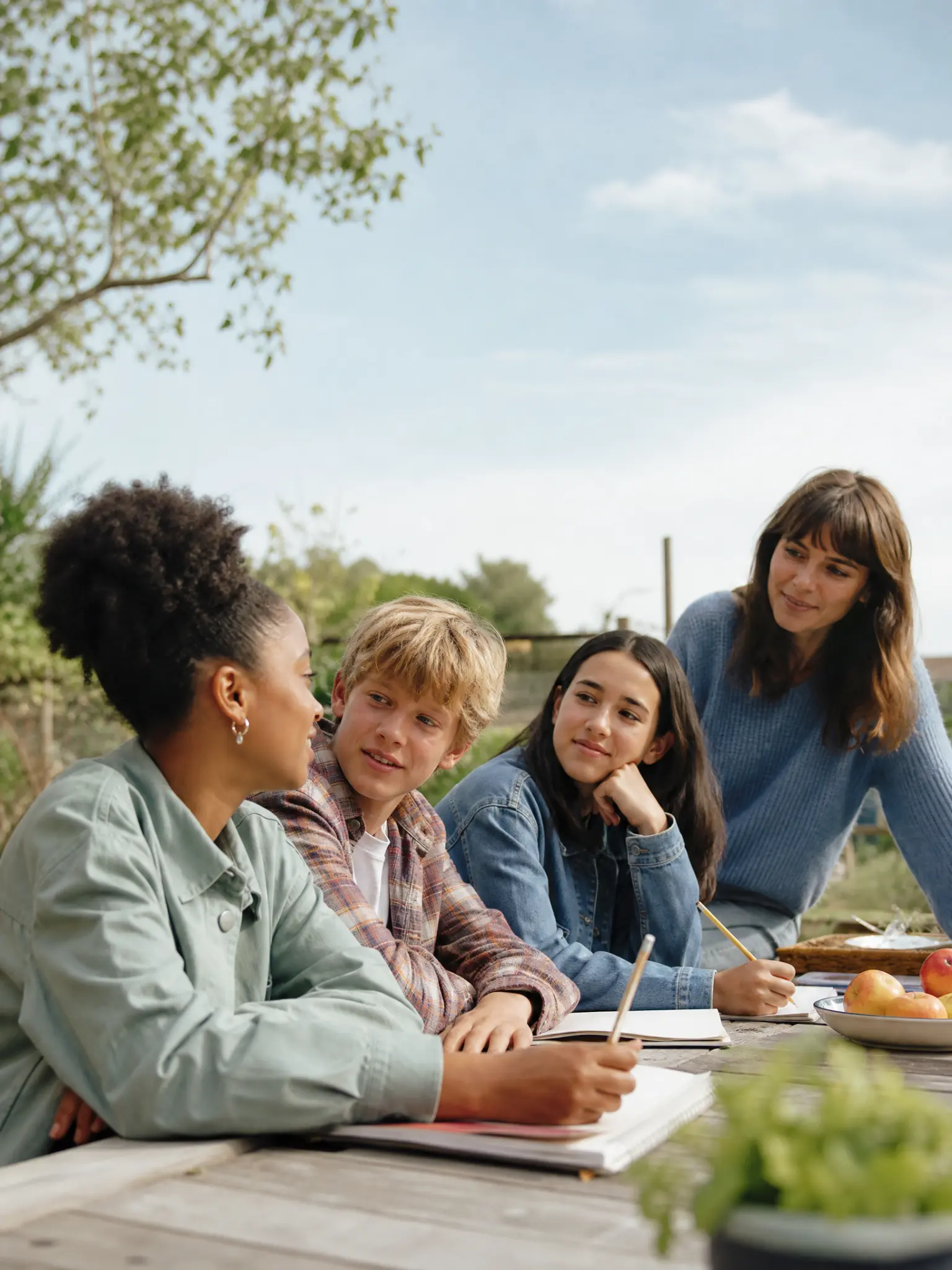 A group of teens learning together outdoors